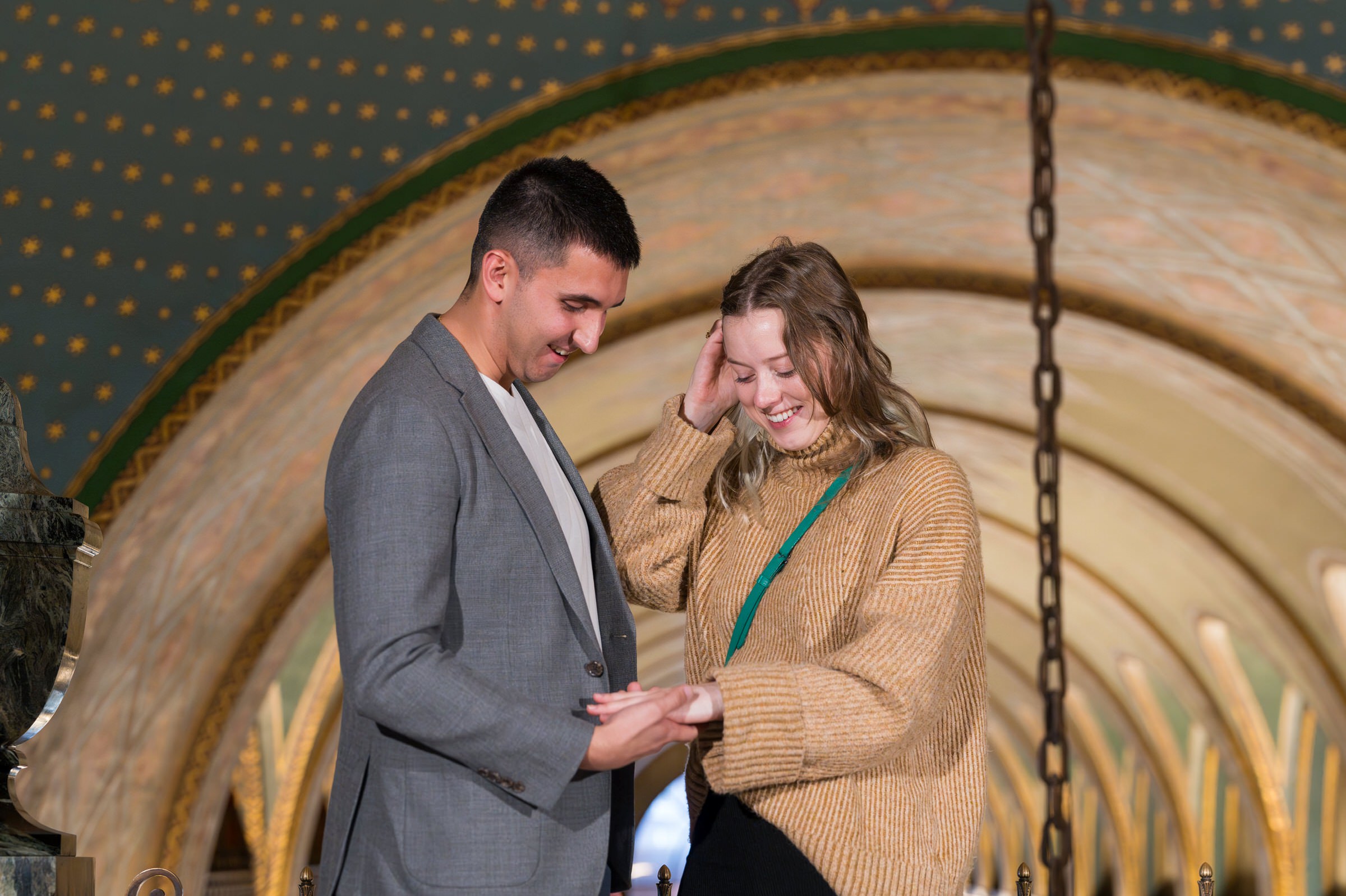 A fiancee looks at her new engagement ring after herFisher Building proposal in Detroit, Michigan.  