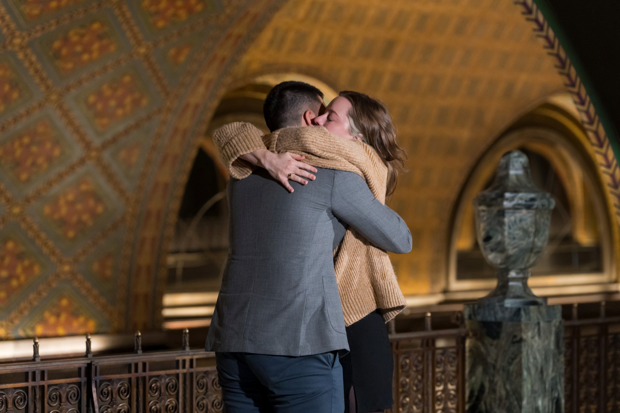 A couple hugs and embraces after their Fisher Building proposal. 