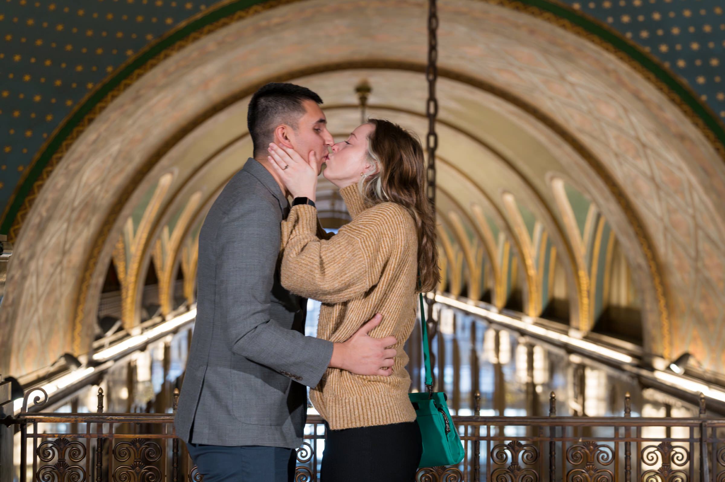 A couple kisses after their Fisher Building proposal. 