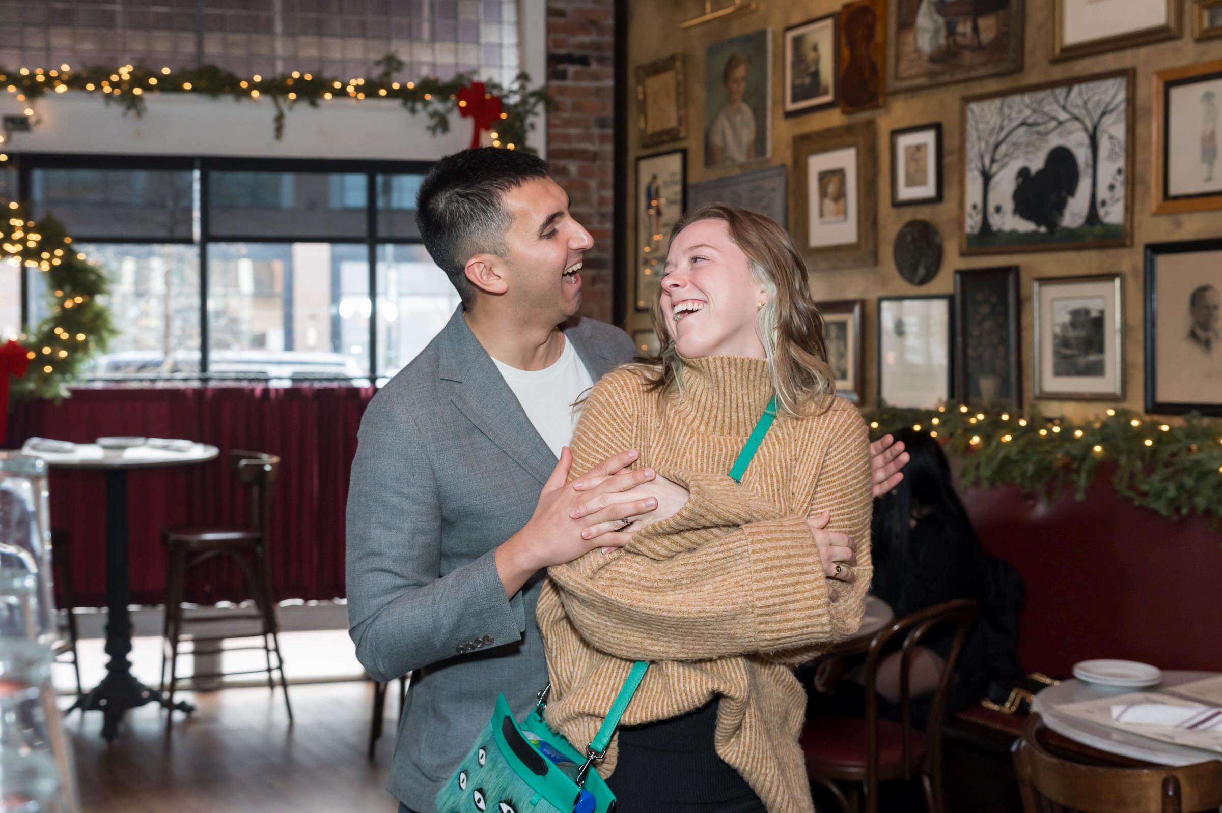 A couple celebrates their proposal with family at Ottava Via in Corktown, Detroit. 