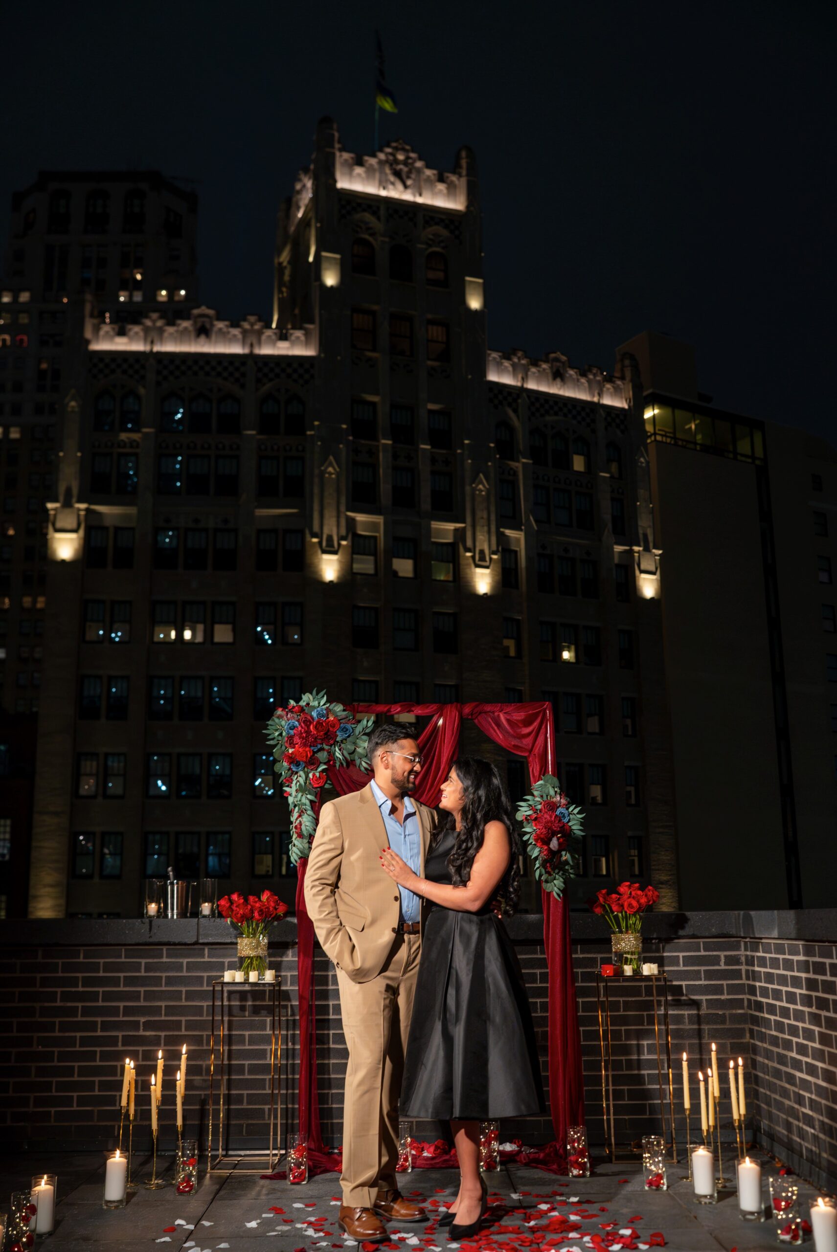 A couple poses for a portrait at the spot of their rooftop Shinola Hotel proposal.