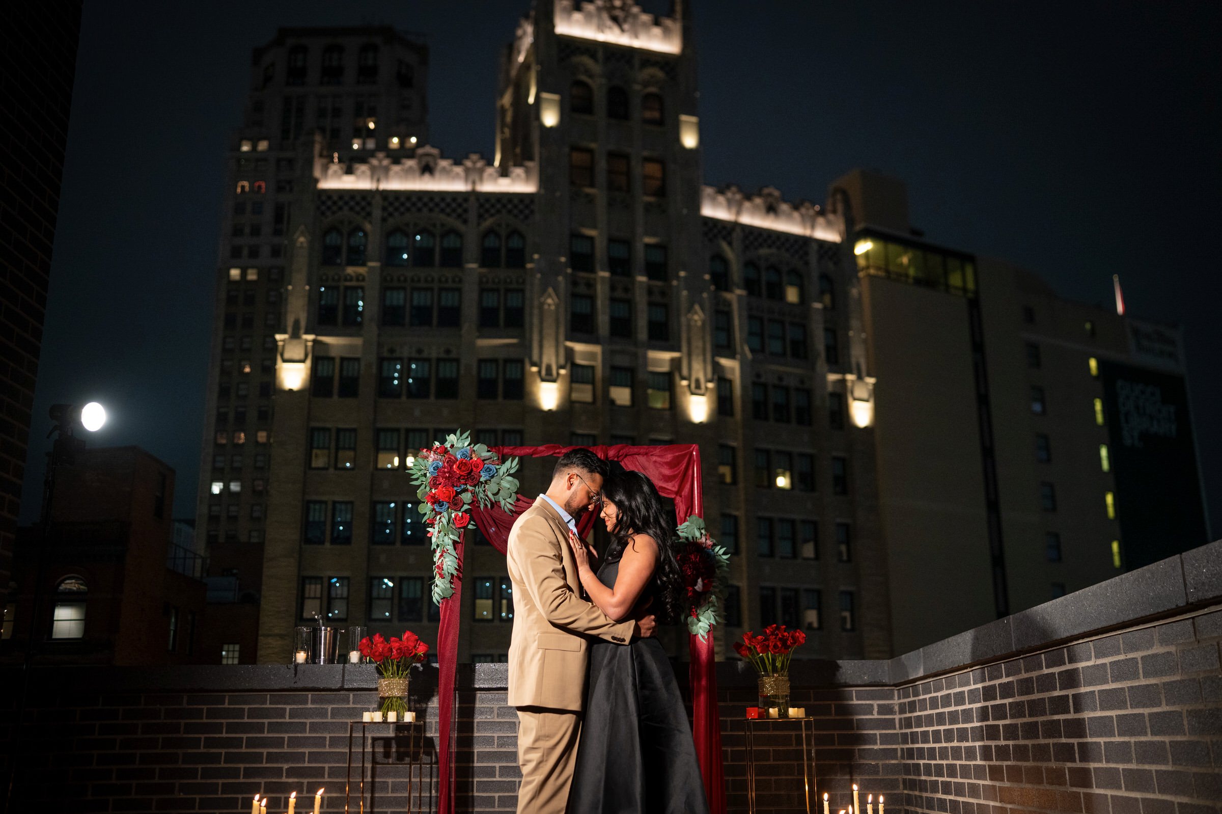 A couple hugs at the spot of their rooftop Shinola Hotel proposal.