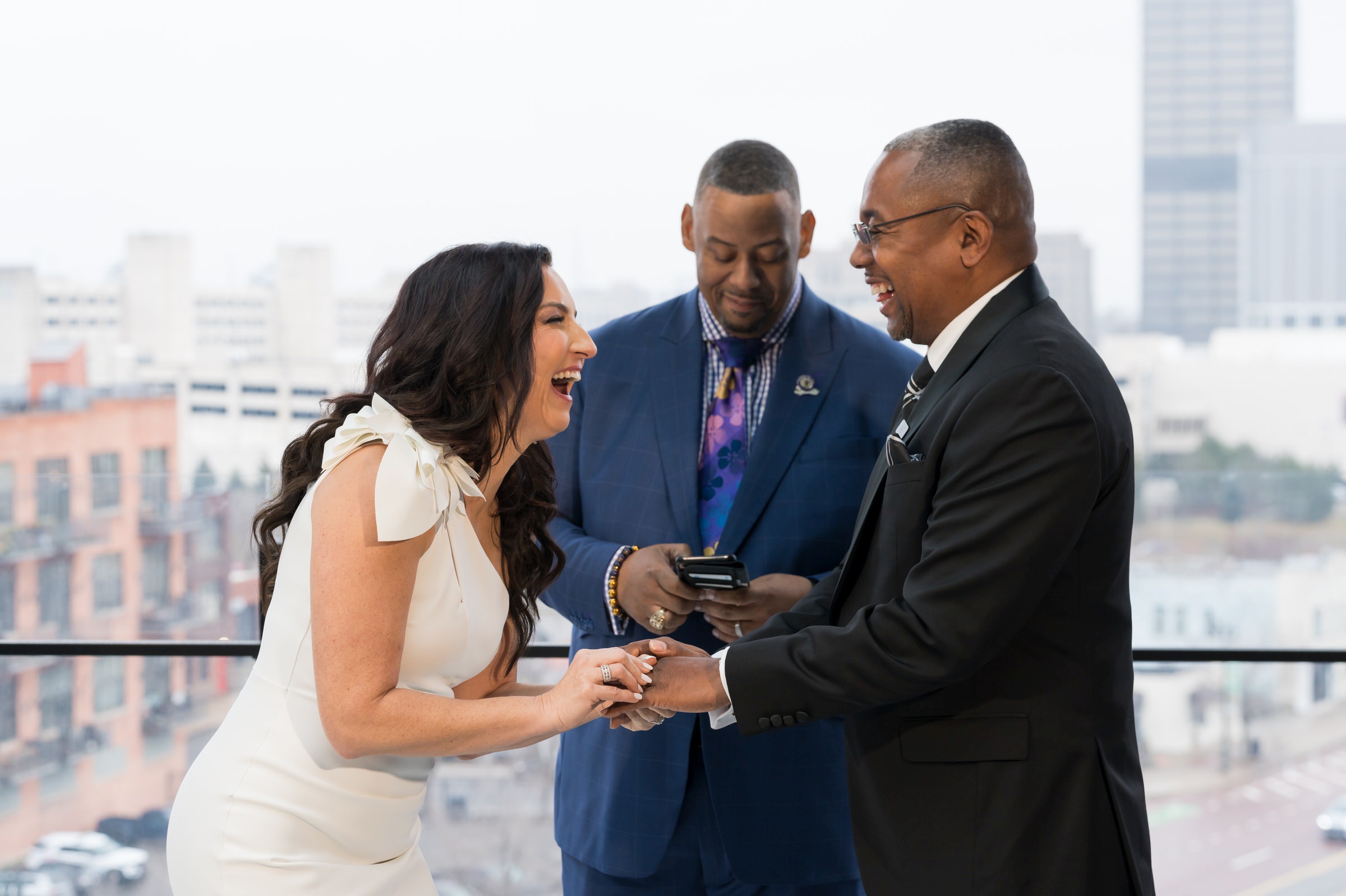 A couple exchanges rings during their Detroit Godfrey Hotel wedding. 