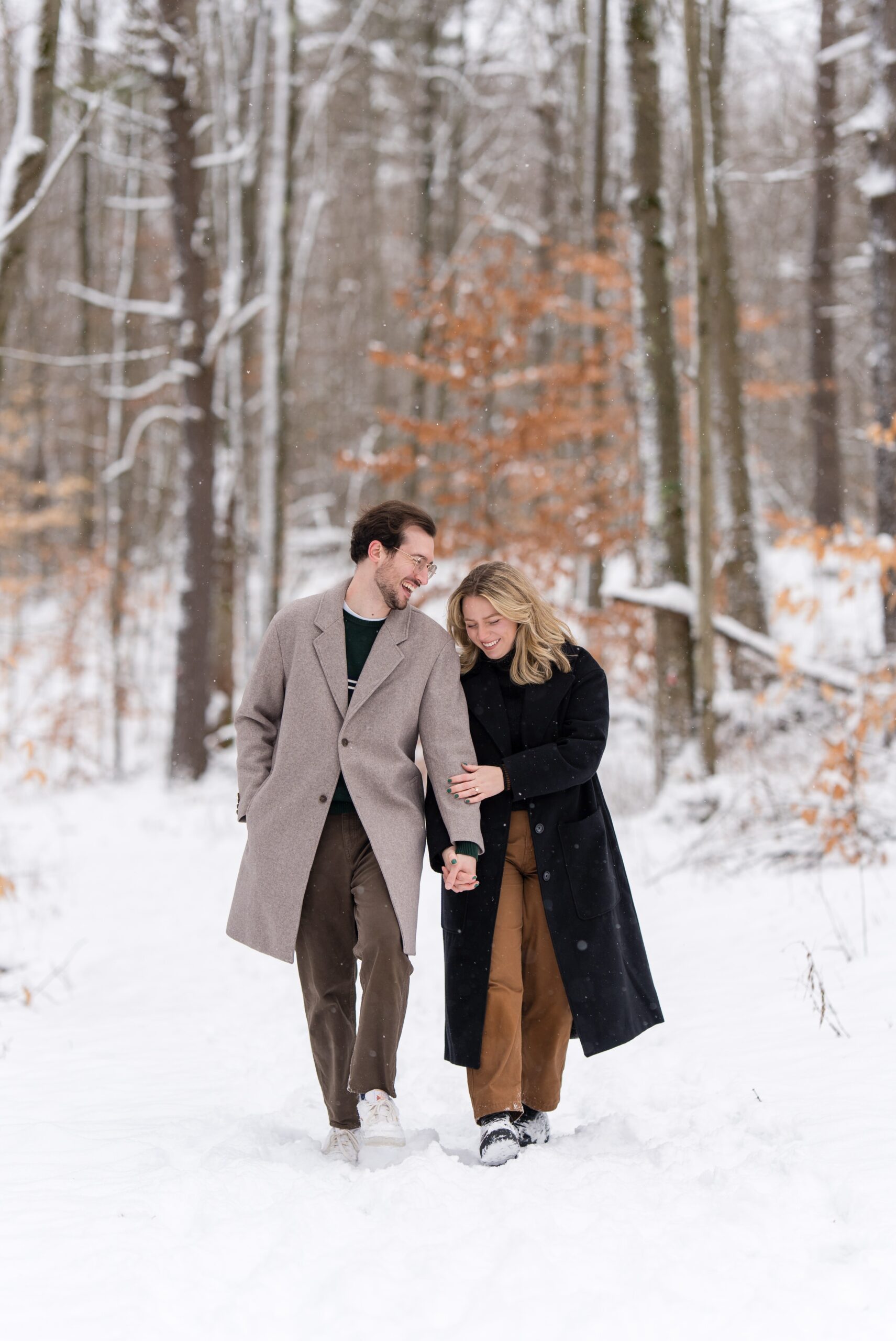 A couple walks along a snow covered path after their Getaway proposal