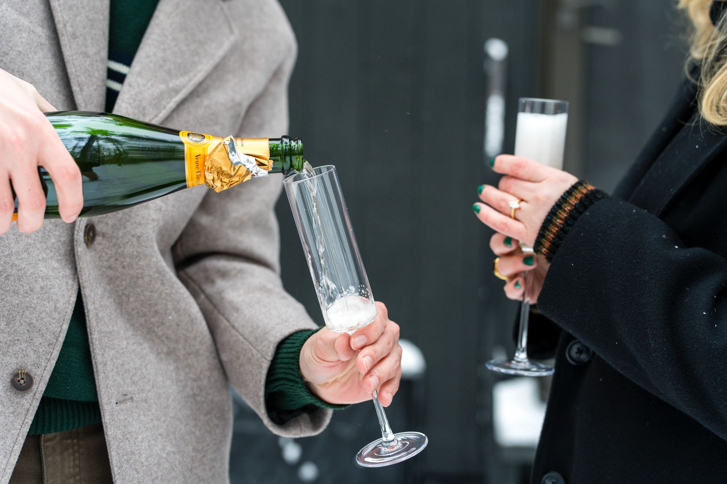 Champagne flows into a champagne flute during a proposal.  