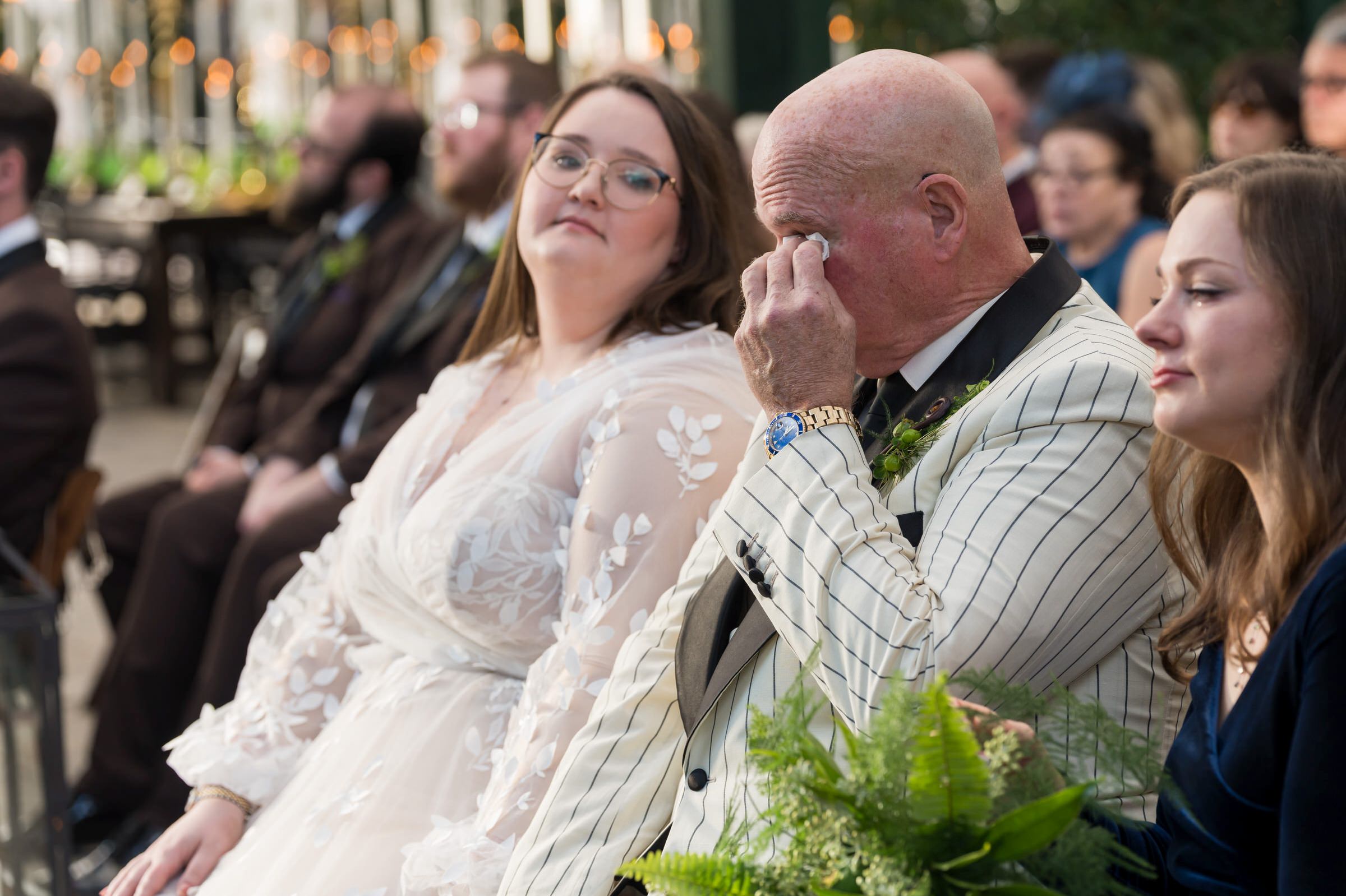 A dad wipes away tears during a Planterra wedding ceremony.  