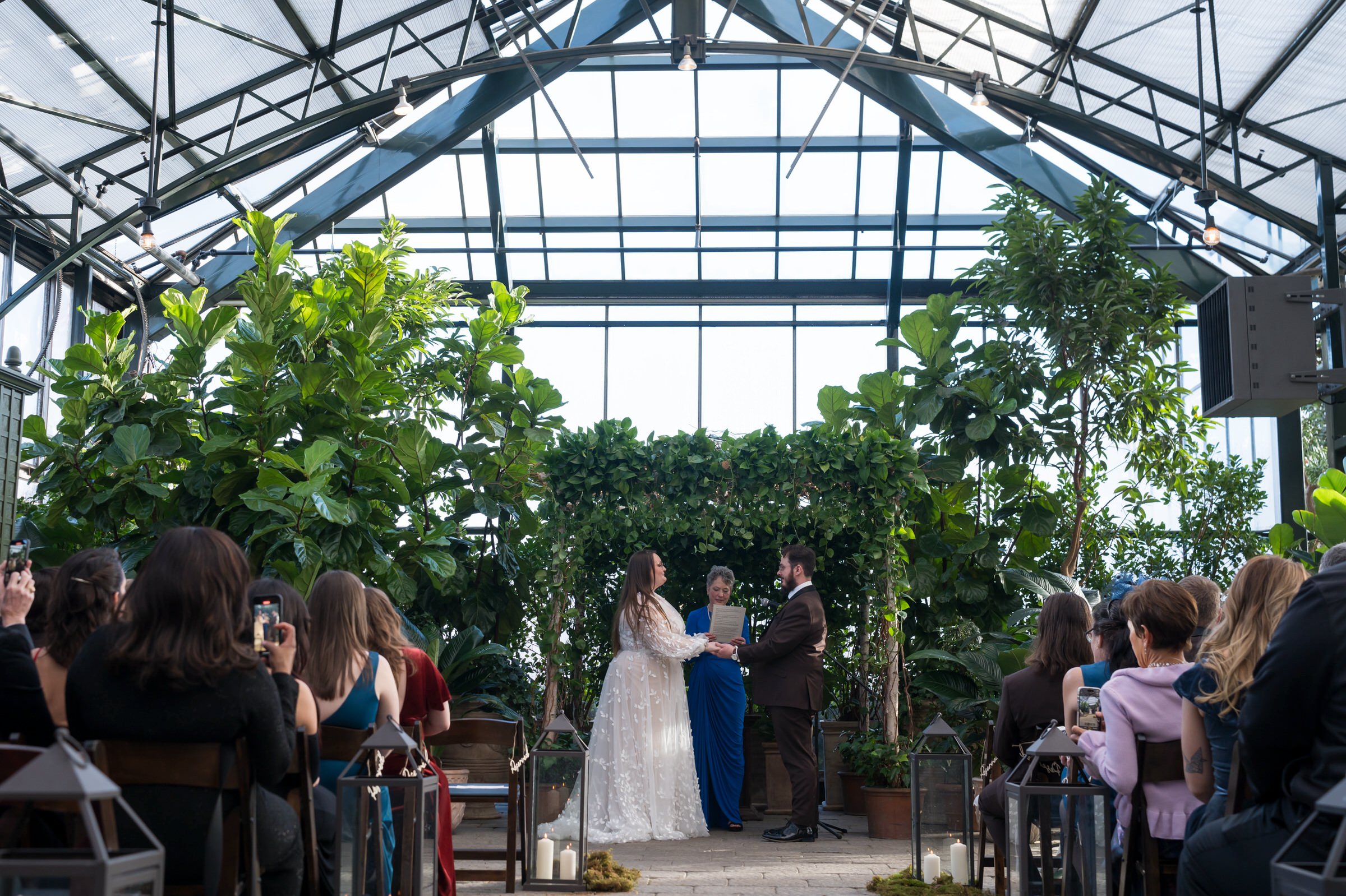 A bride and groom exchange vows during their Planterra wedding ceremony.   