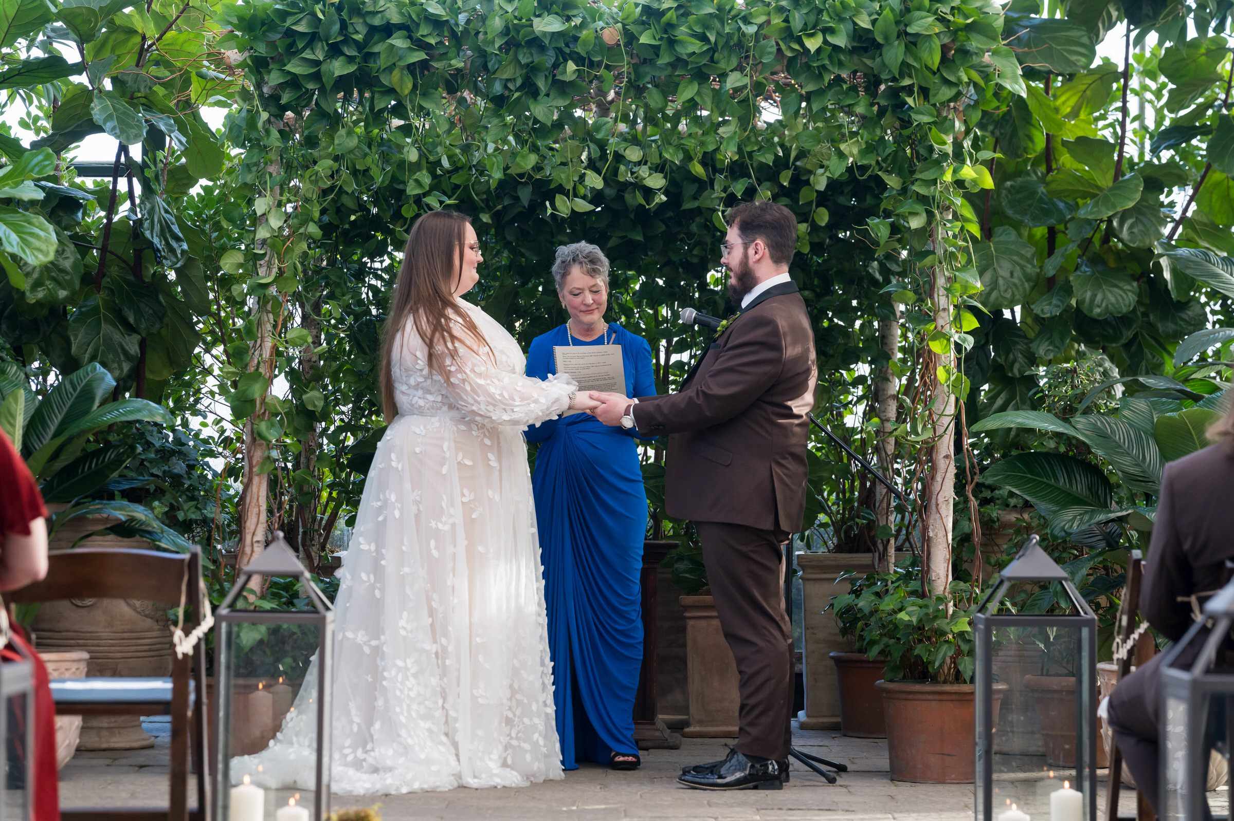 A bride and groom exchange vows during their Planterra wedding ceremony.   