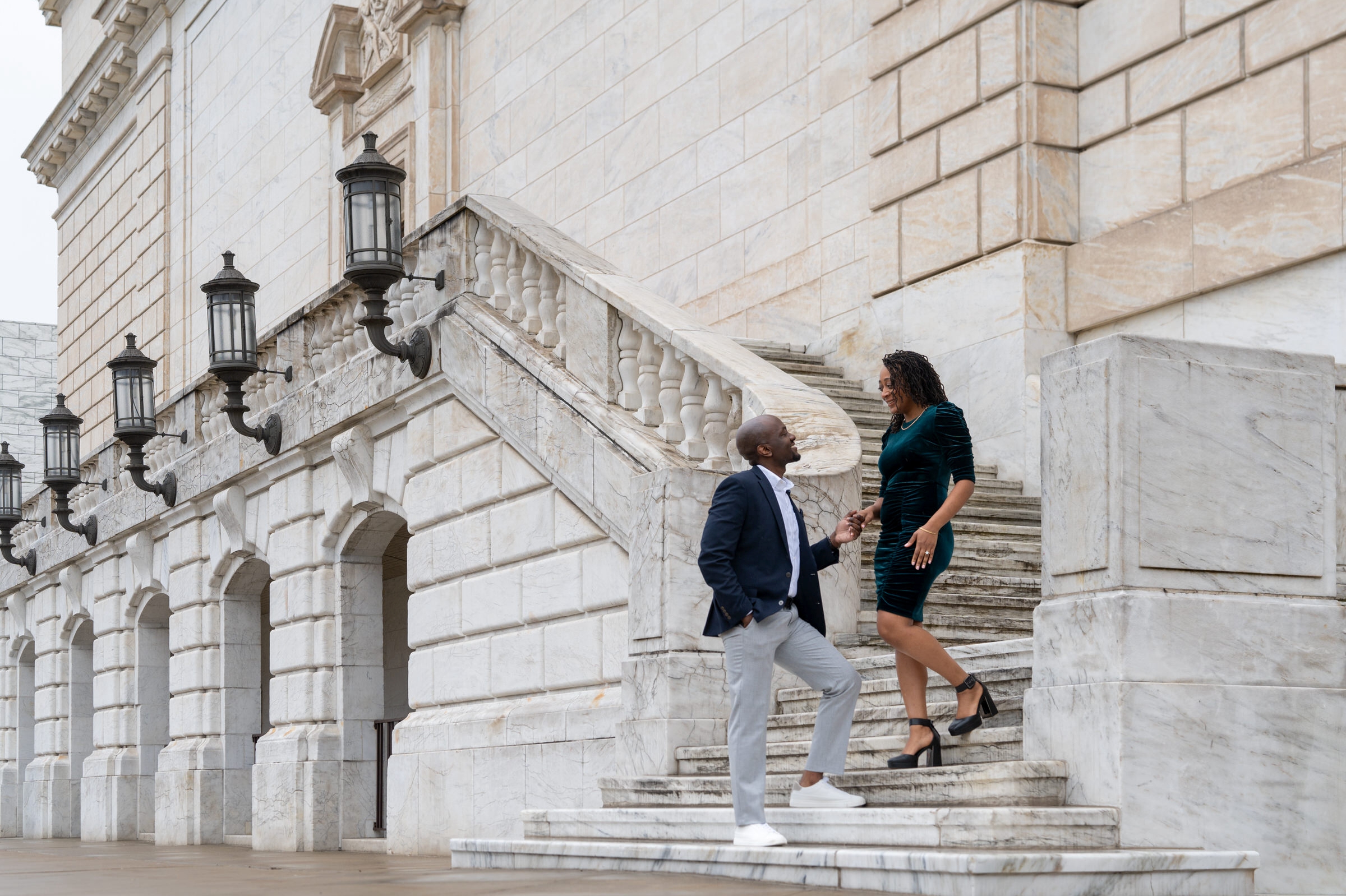 A newly engaged couple poses on the steps of the Detroit Institute of Arts following a marriage proposal at the DIA.