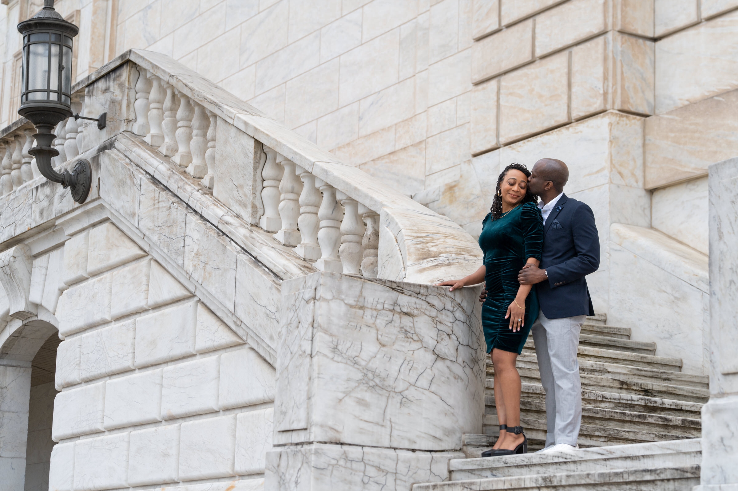 A newly engaged couple poses on the steps of the Detroit Institute of Arts following a marriage proposal at the DIA.