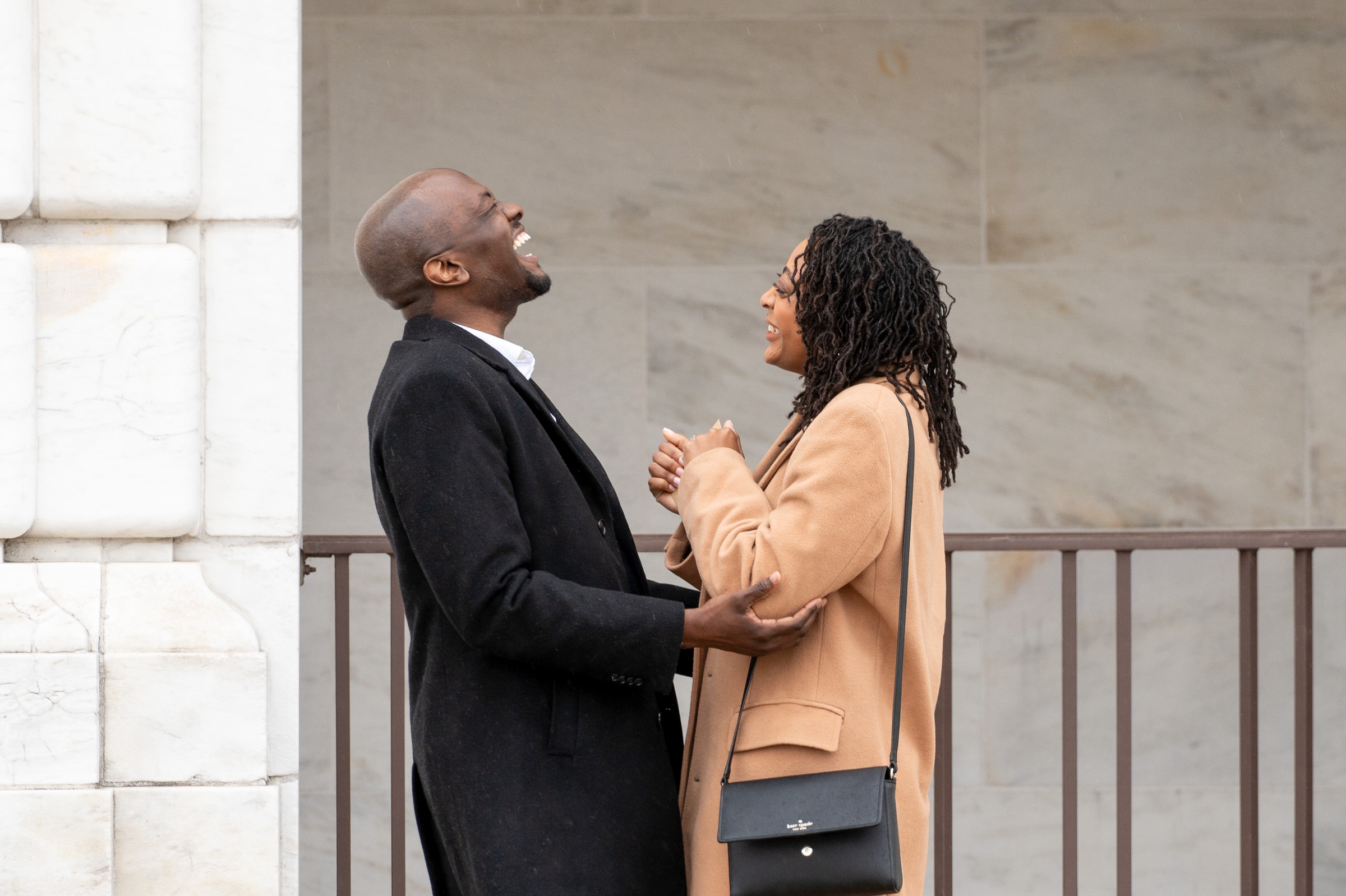 A couple reacts with joy and laughter during a marriage proposal at the DIA.  