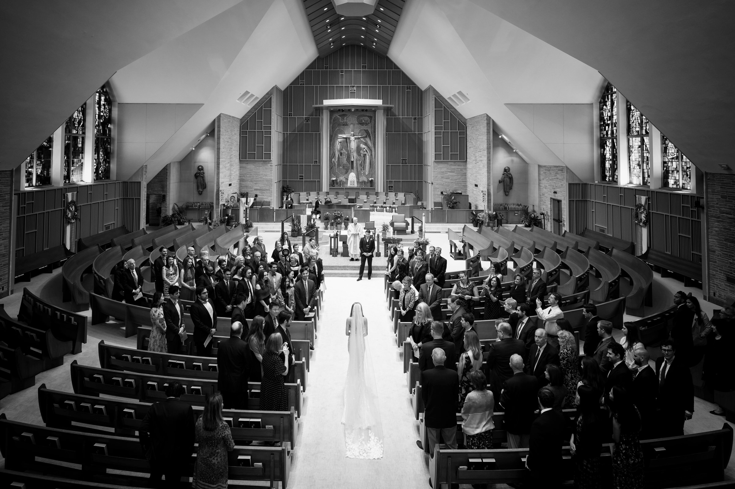 The bride walks down the aisle at her Holy Name Catholic Church wedding in downtown Birmingham.