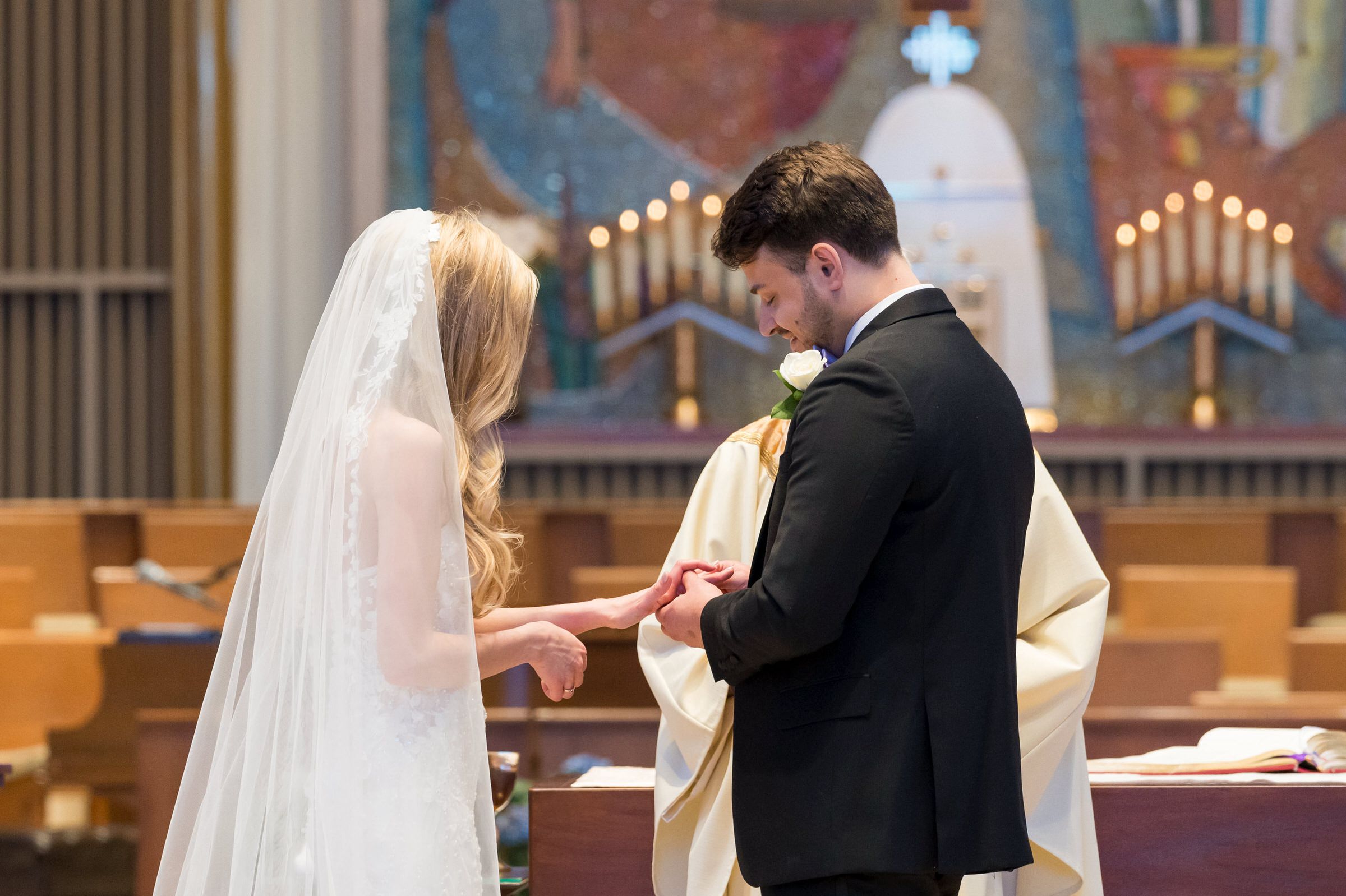 Vows and rings are exchanged at a Holy Name Catholic Church wedding.  