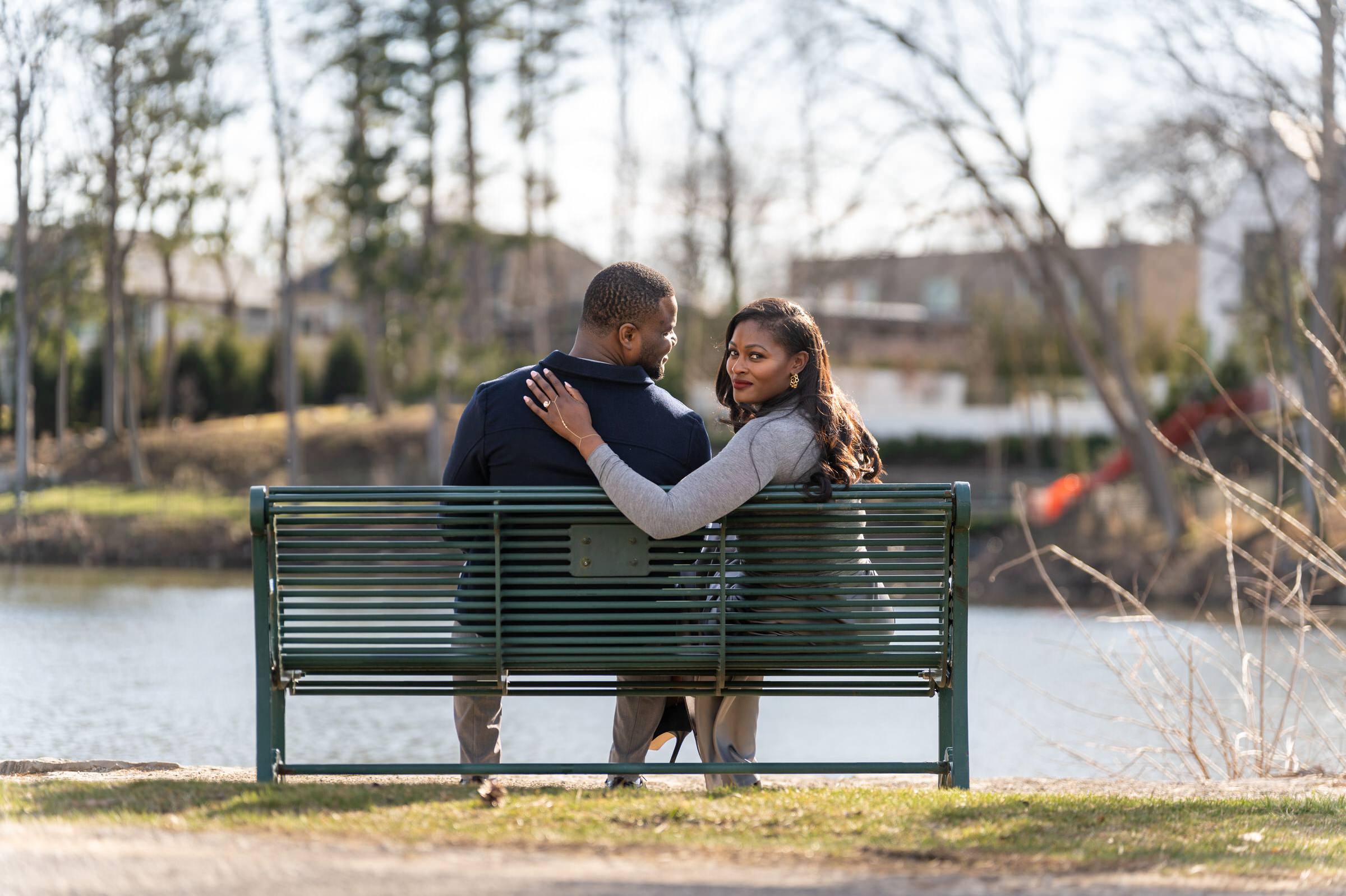 A couple sits on a bench after their proposal at Quarton Lake.  