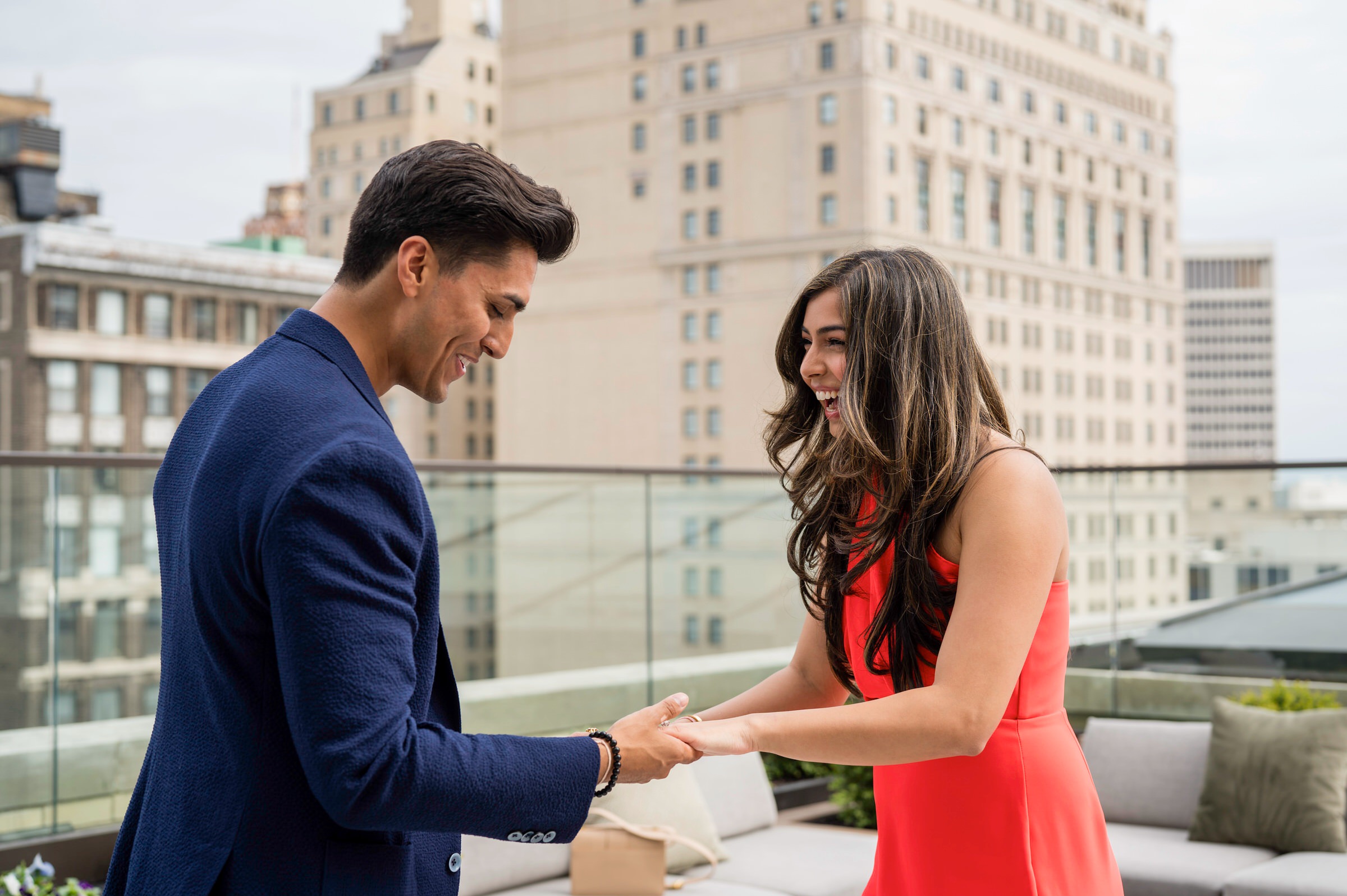 A fiancé reacts to her Kamper's Rooftop Proposal atop the Book Tower in Detroit.  