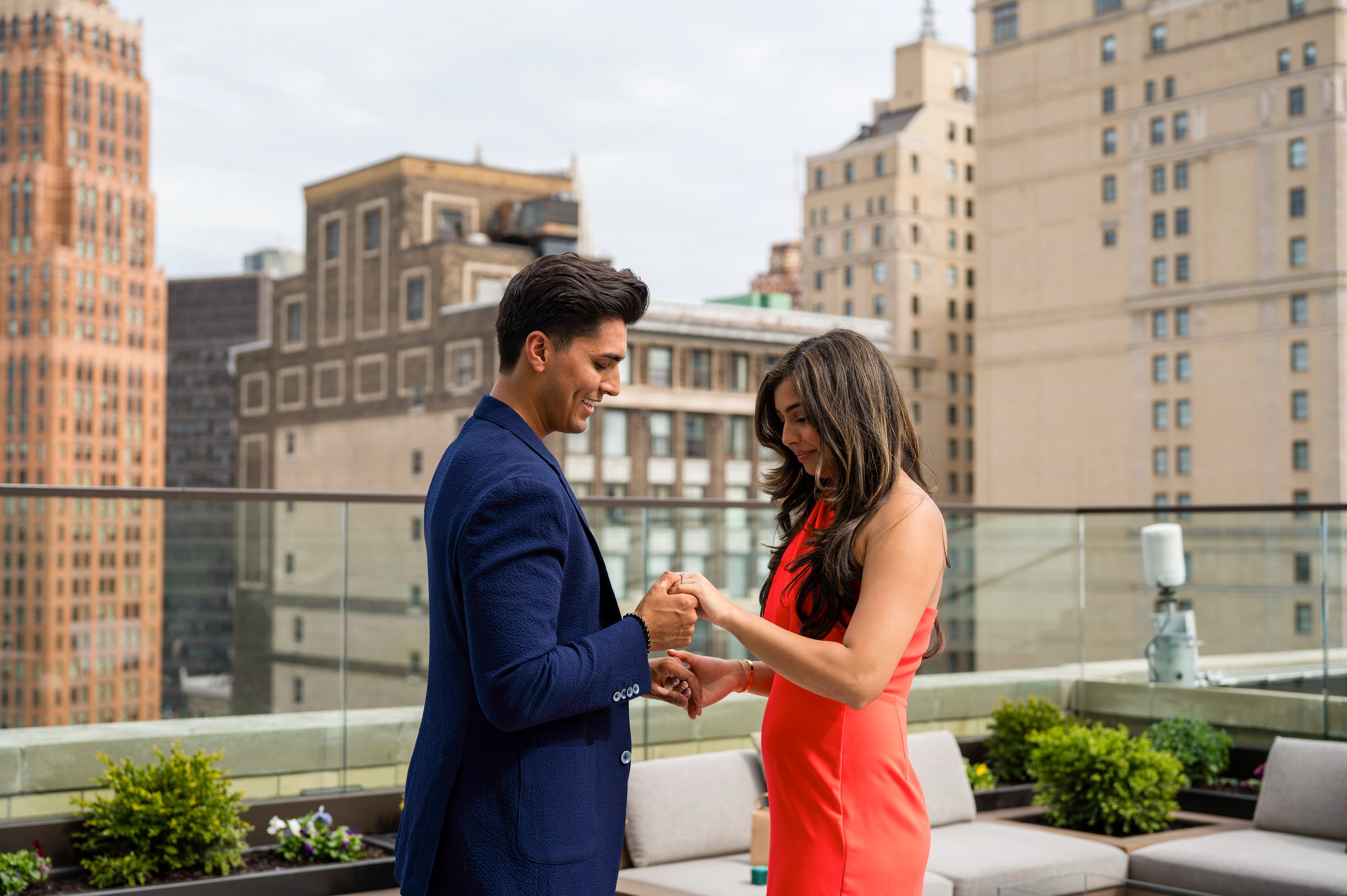 A fiance looks at her ring for the first time following a Kamper's Rooftop Proposal atop the Book Tower in Detroit.  
