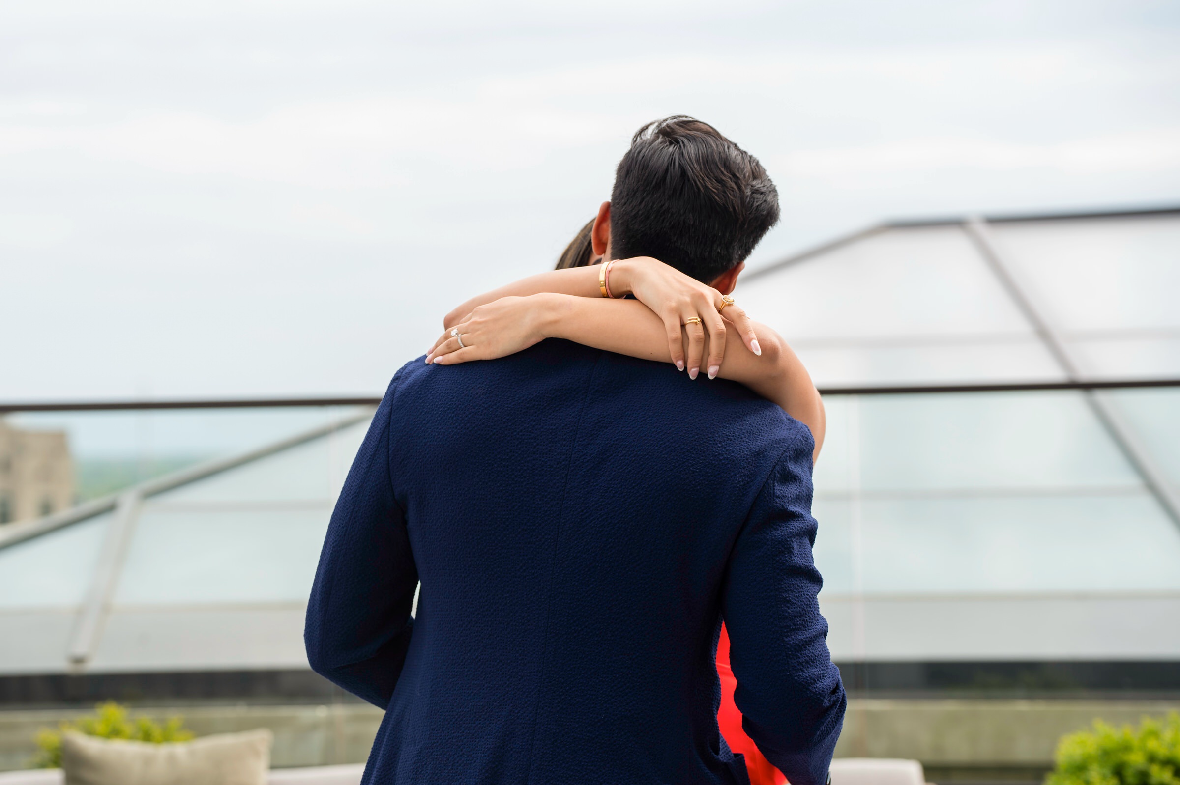 A couple hugs moments  after their Kamper's Rooftop Proposal atop the Book Tower in Detroit.  