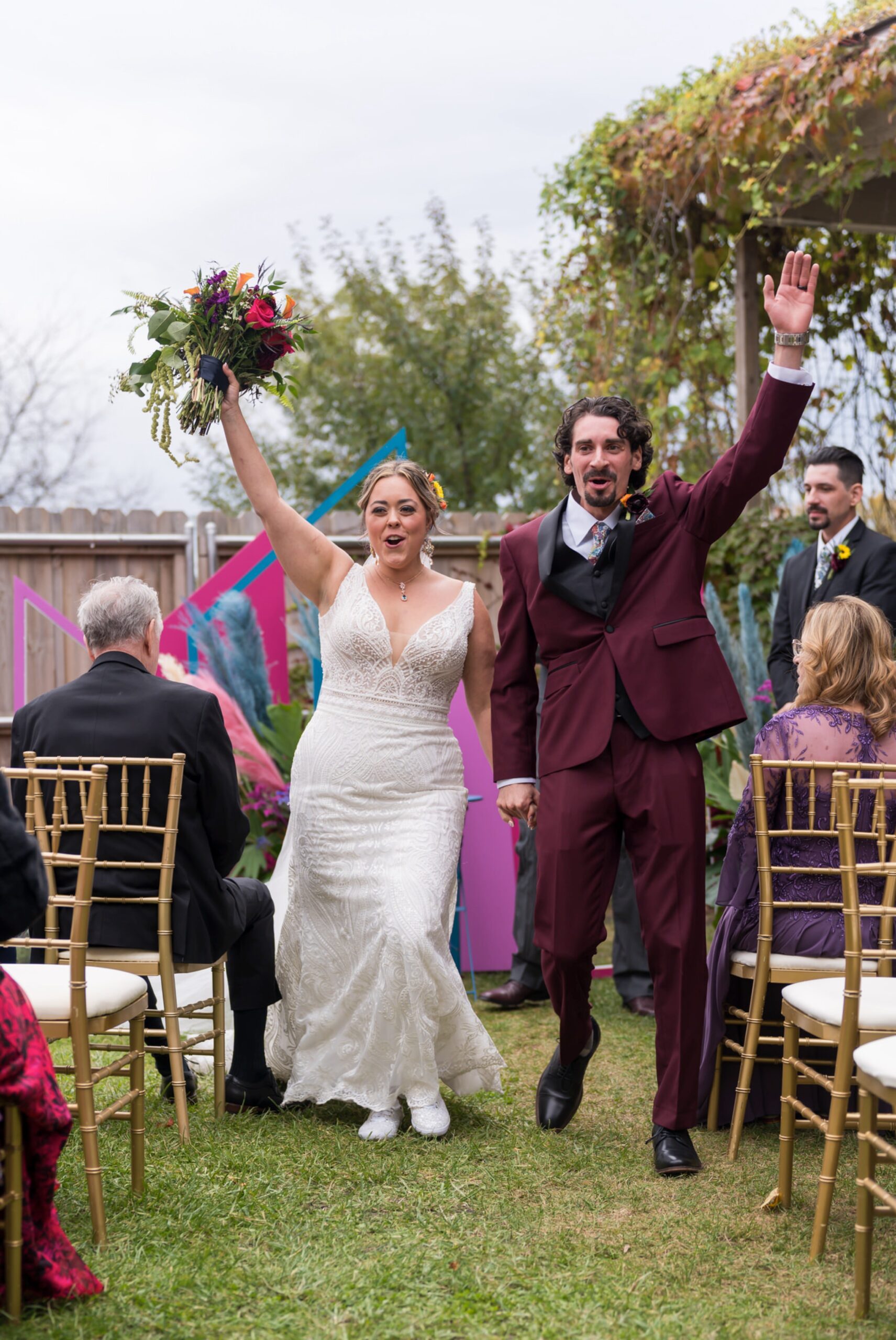 A bride and groom celebrate after being announced husband and wife at their Jam Handy wedding.  