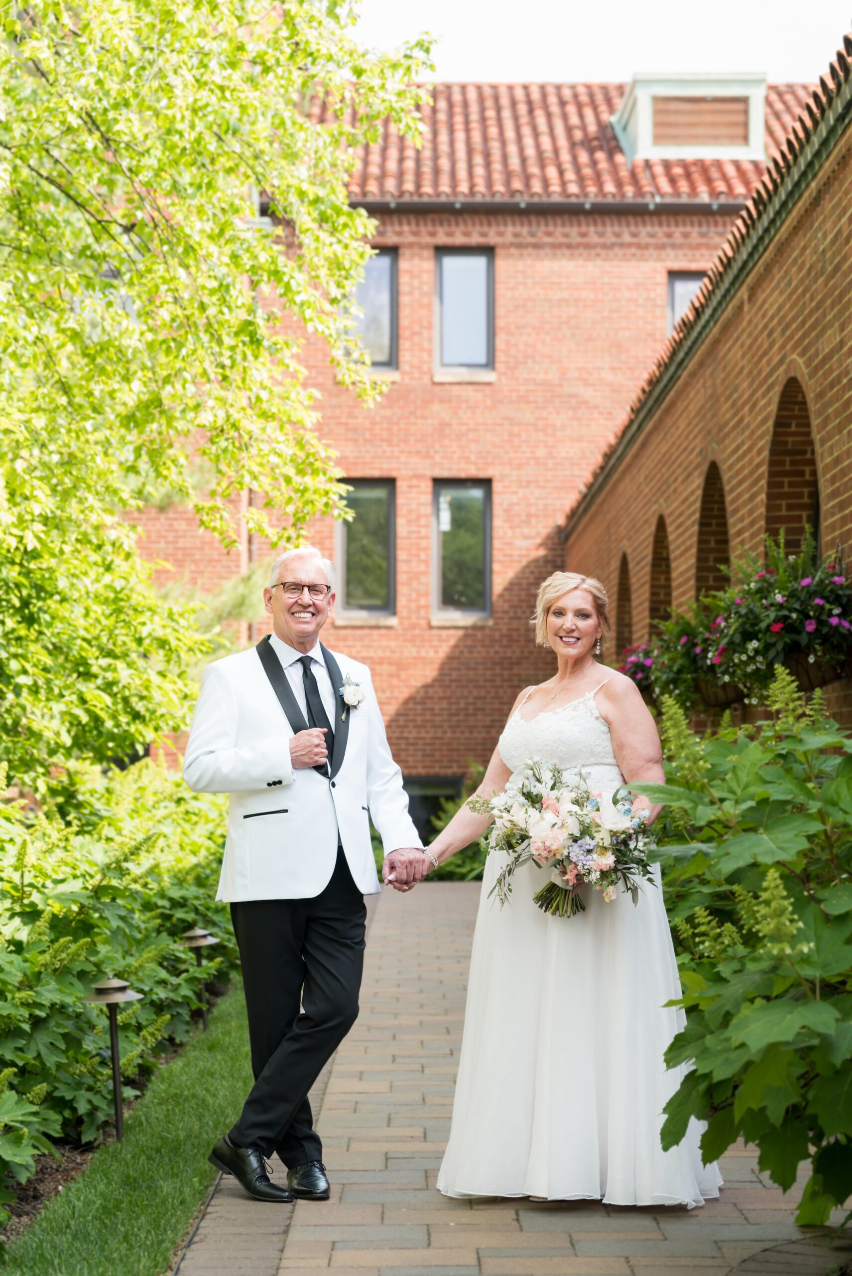 A couple poses for a portrait in the courtyard of their private wedding at St. John's Resort.