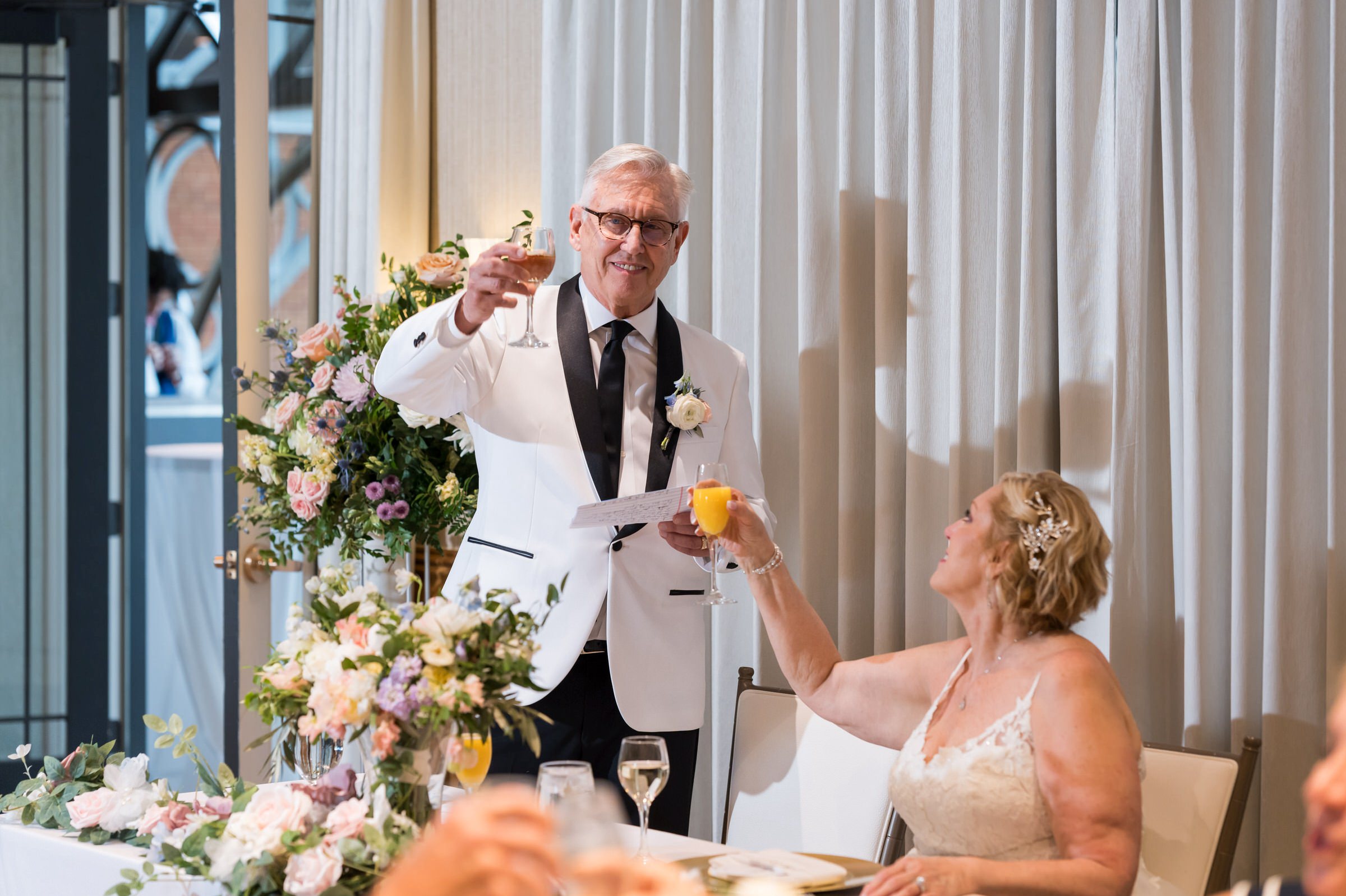 A groom toasts his bride in the Abbey at their private wedding at St. John's Resort.