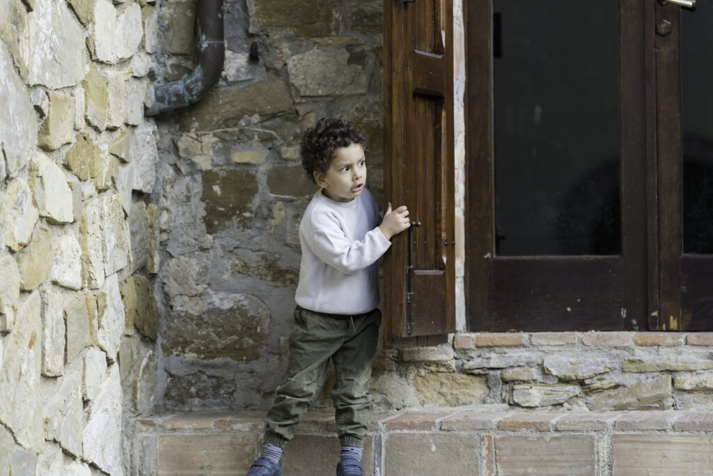 Nephew peeking out at Welcome Party at Quercia al Poggio 