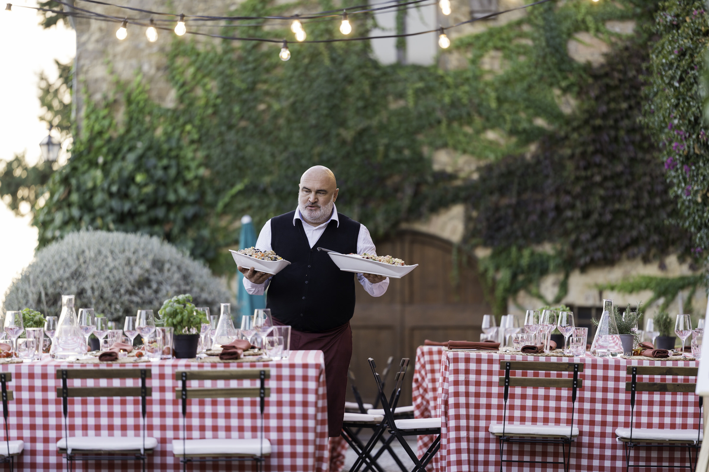 Waiter plates food at Welcome Party at Quercia al Poggio 