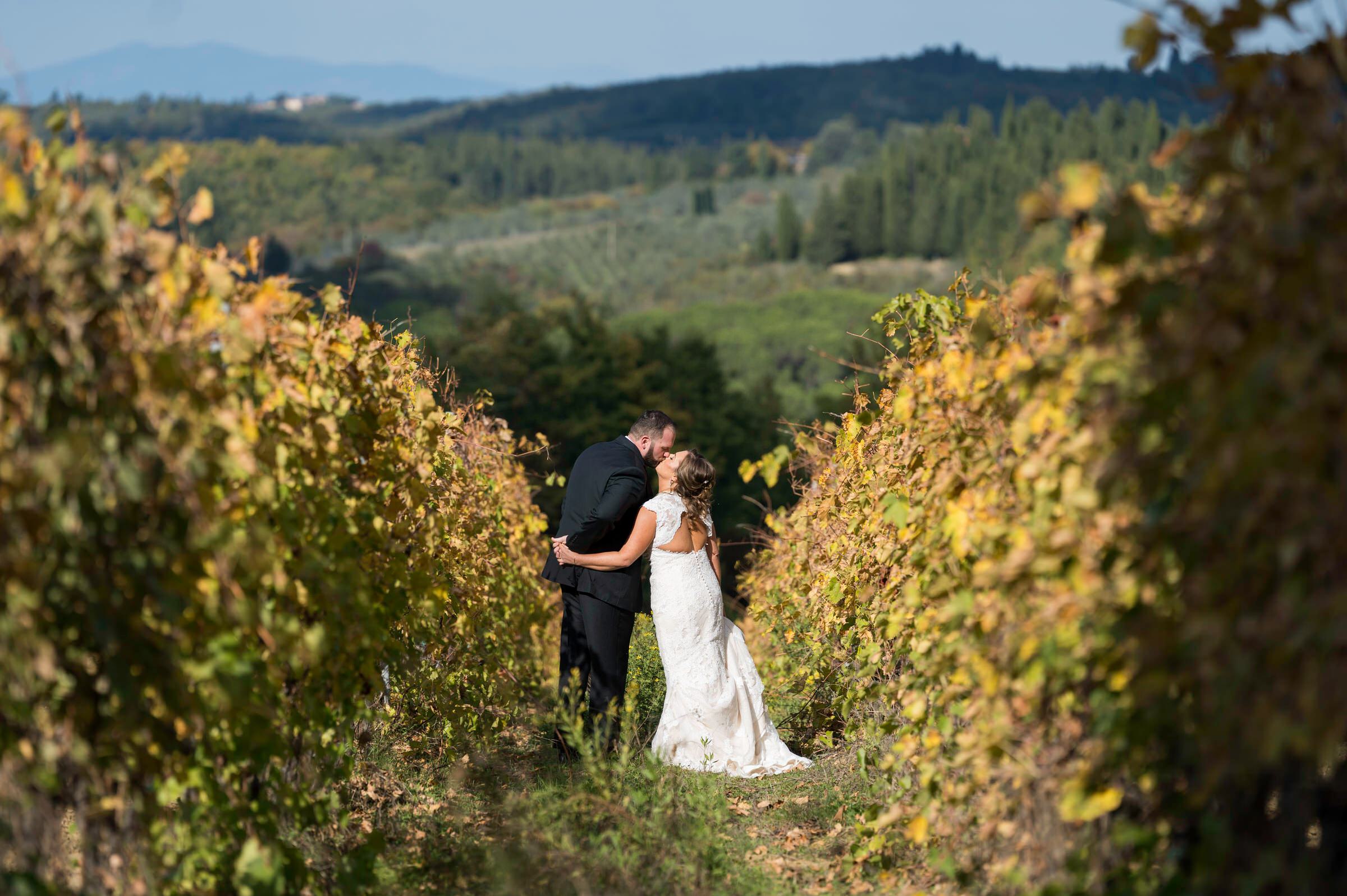 AJ and Kate kiss in the vineyards during Quercia al Poggio wedding
