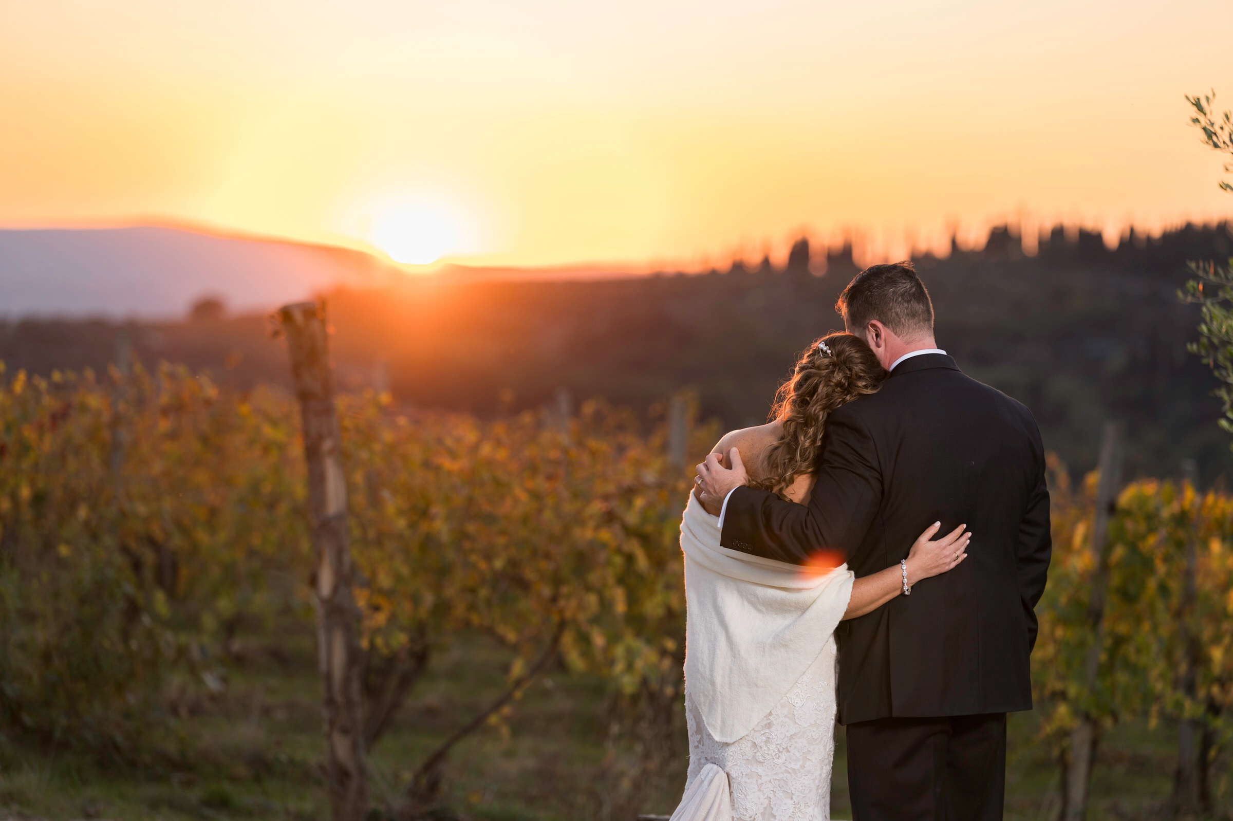 Golden hour with bride and groom looking at vineyard during Quercia al Poggio wedding