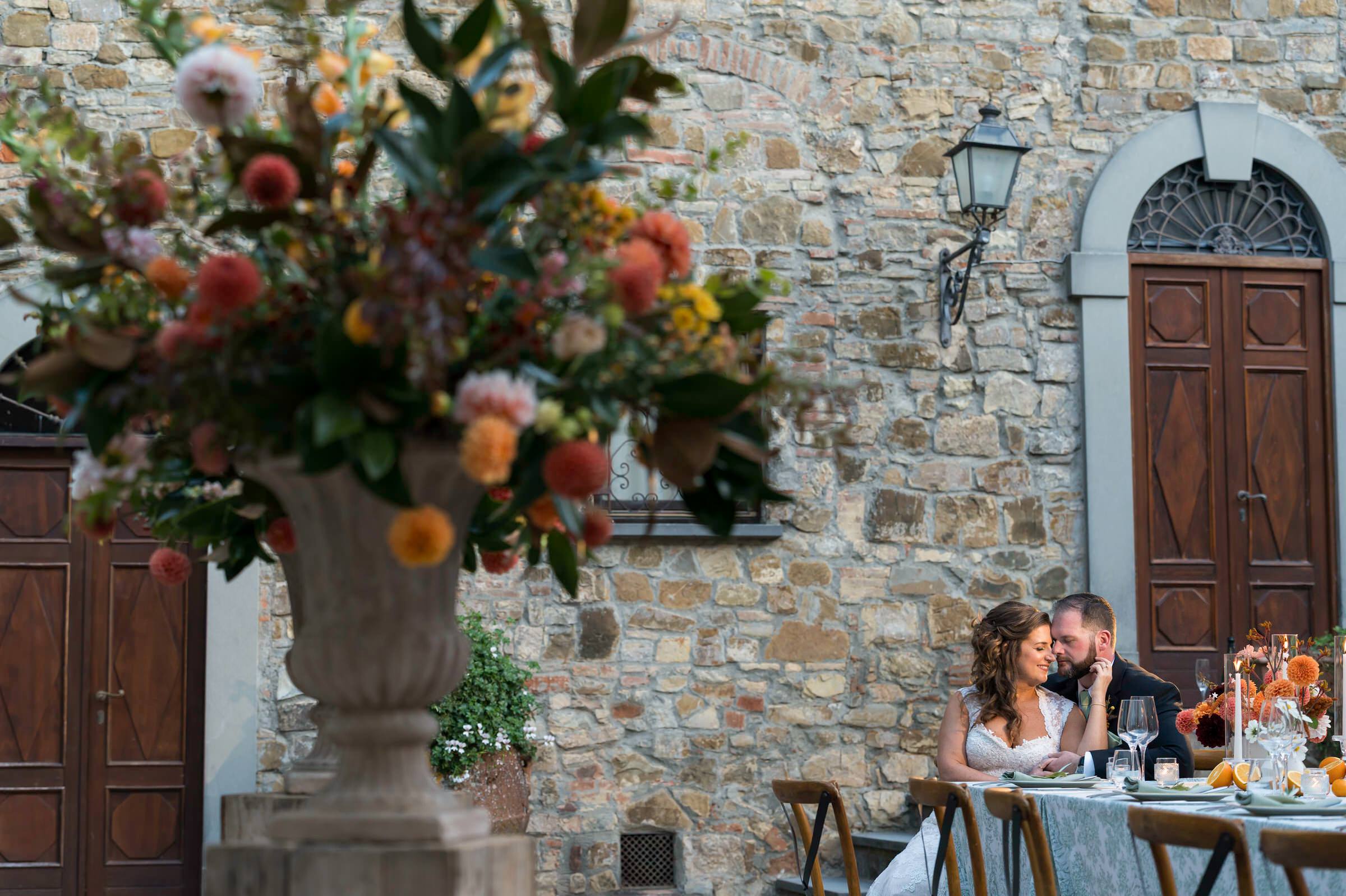Bride and groom at table during Quercia al Poggio wedding
